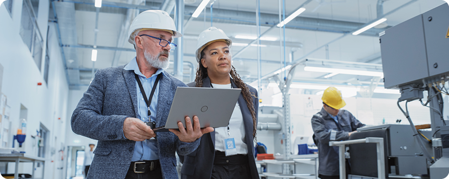 one male and female both in hard hats in a factory setting